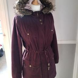 ladies winter coat. size 8. wine coloured. fully lined. fleece hood with fur collar. chunky zip with stud fastenings and tie at waist. 2 large pockets. can post