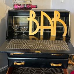 Recycled bureau bar or writing desk in opulent gold and black
H 100cm
W 76cm
D 40cm

Free local delivery or £1 per mile over 3 miles