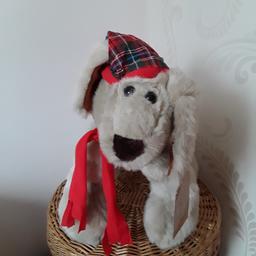 Cute furry dog new and unused item. Wearing a delightful tartan hat and red scarf. Soft pads on each paw.