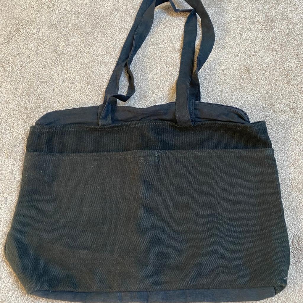 Black jute/cloth bag with zip, handles and large front pocket. Measurements: 42cm/34” x 34cm/13.5”. Lightweight and useful for travel, shopping etc. Had 3 of these and this one been in storage and never got round to using.