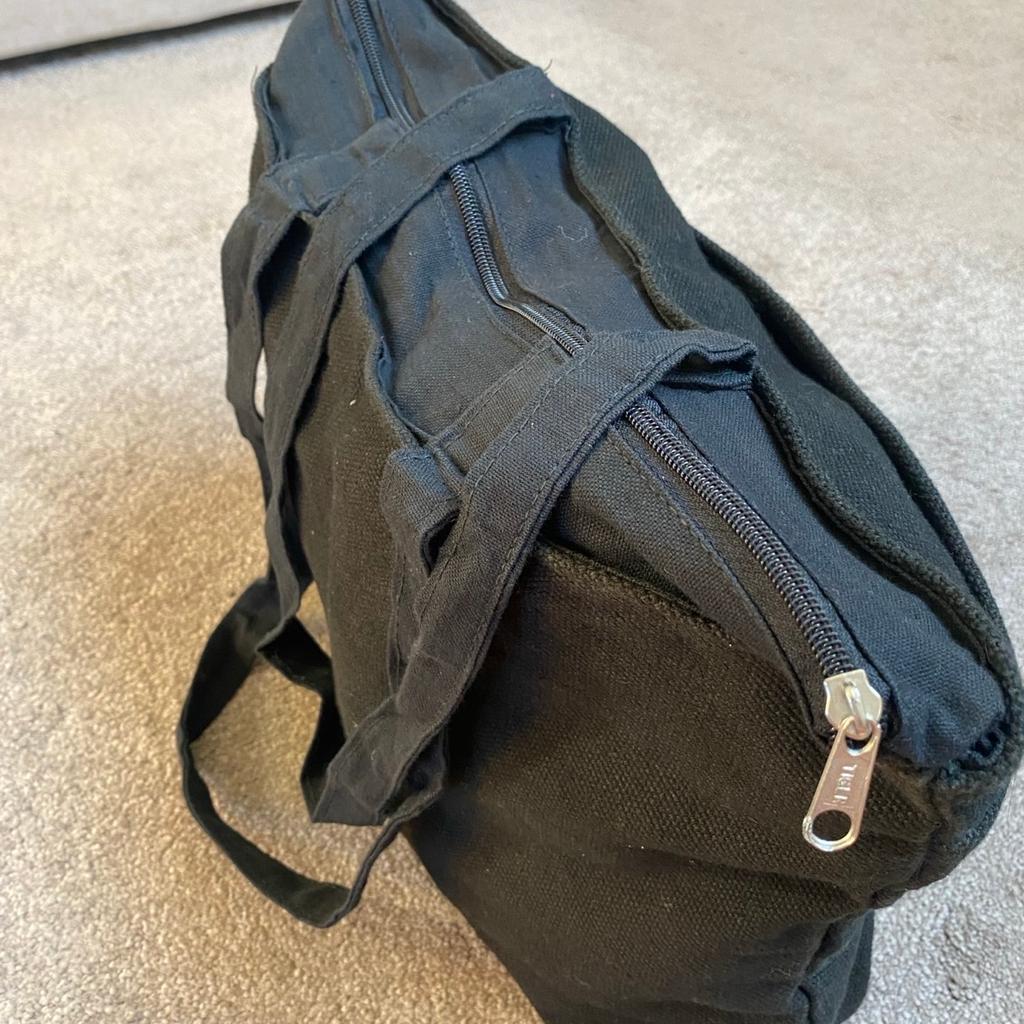 Black jute/cloth bag with zip, handles and large front pocket. Measurements: 42cm/34” x 34cm/13.5”. Lightweight and useful for travel, shopping etc. Had 3 of these and this one been in storage and never got round to using.