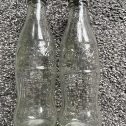 Empty glass Coca Cola embossed bottles with the cap lids
(unsure if need to state the trademark of the bottles)