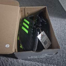 UK size 2 kids football shoes, brand new in original box. Green and blank in colour