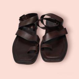 Welcome to the world of Free People's Chocolate Brown Romeo Wrap Sandals. This unique, stylish footwear piece is a must-have for those looking to add some extra flair to their shoe collection. These sandals come in a size 5 small, and are designed with comfort and style in mind.

Crafted from high-quality materials, these sandals are built to last. The unique chocolate brown color is versatile enough to match with any outfit, making hem perfect for any occasion - whether you're dressing up or do