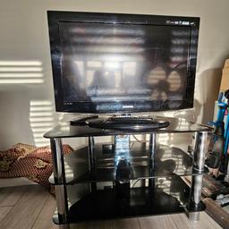 Black glass stand and 32inch Samsung Tv- (its not a smart tv- but with a firestick can give you other channels).  It does not come with a firestick.

Remote control is included.