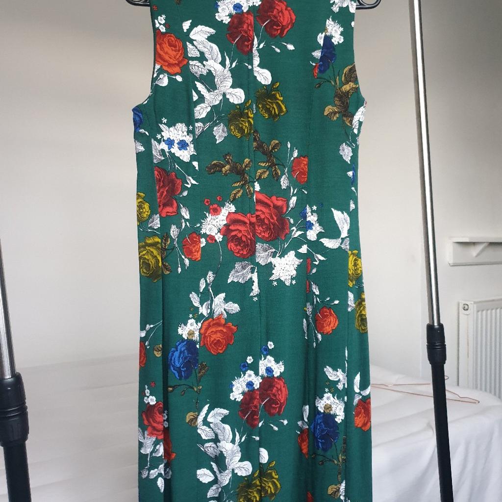 Green floral short summer dress with pockets. The sizing is small so listed as 10 instead of 12. Lovely dress. Perfect for warm summer days.