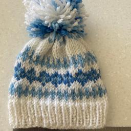 Children’s handmade / Hand knitted pom-pom hat 
Blue and white 
Measurements in photograph (14 cm)
Approximately 3 to 6 months
Listed on multiple sites