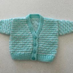 Newborn babies, hand knitted cardigan, 
mint green, & white coloured - unisex for boy or girl. 
Measurements in the photographs 
22 cm across the chest 
21 cm from the neck to the hem 
Handmade / handknitted
Listed on multiple sites