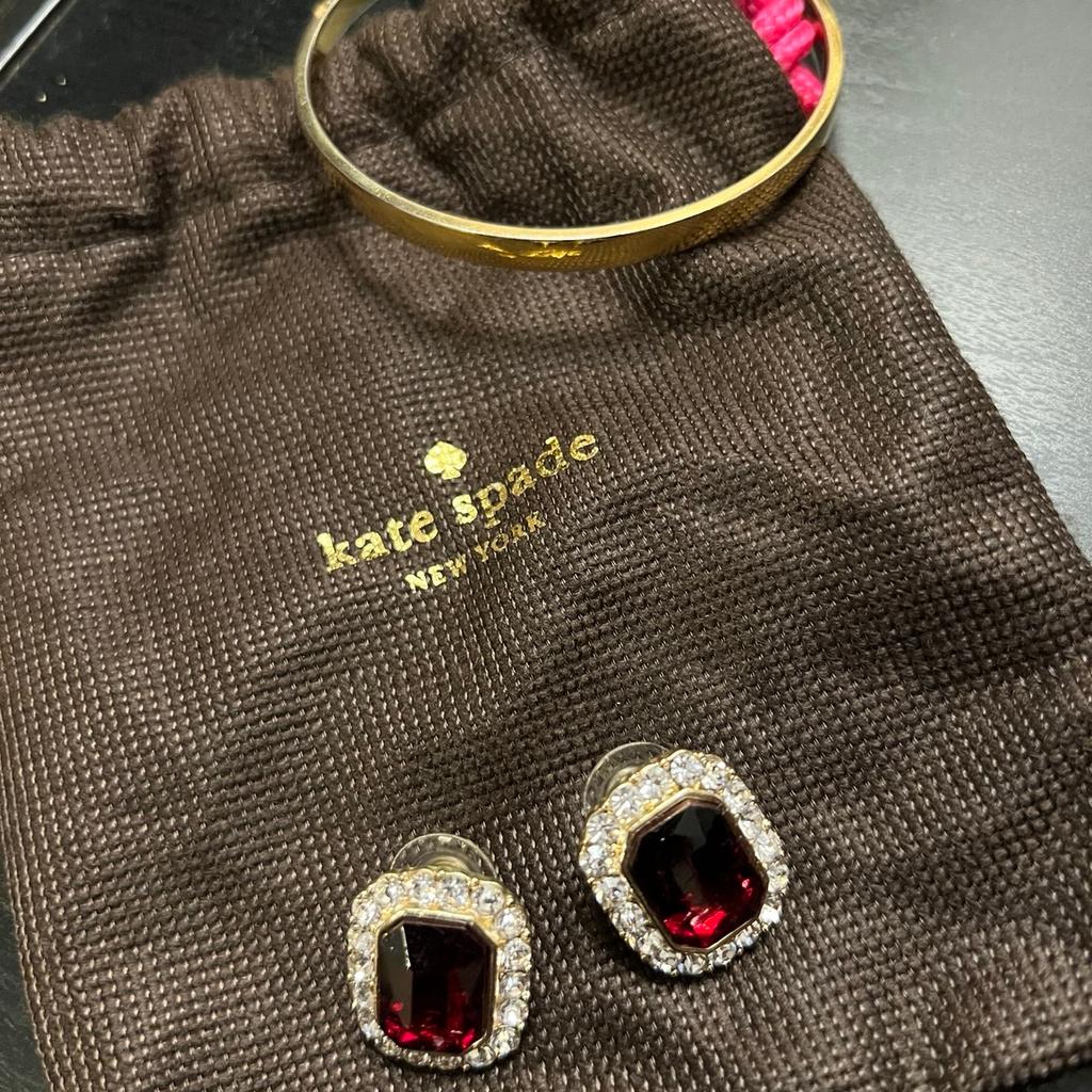 Gold coloured bangle and costume jewellery earrings from Kate Spade with cloth bag