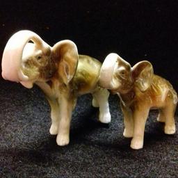 Pair of Vintage Highly Collectible Royal Dux Porcelain ELEPHANTS dating from the 1950s
(Trunks up so considered lucky)
Fully marked on underside
Excellent condition
(Priced to sell: Independent Valuation £60)

Postage possible at extra cost
Payment by PayPal so buyer protection will apply.