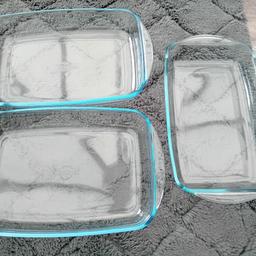3 rectangular roasting / baking dishes . 2 are ocuisine and 1 has no name