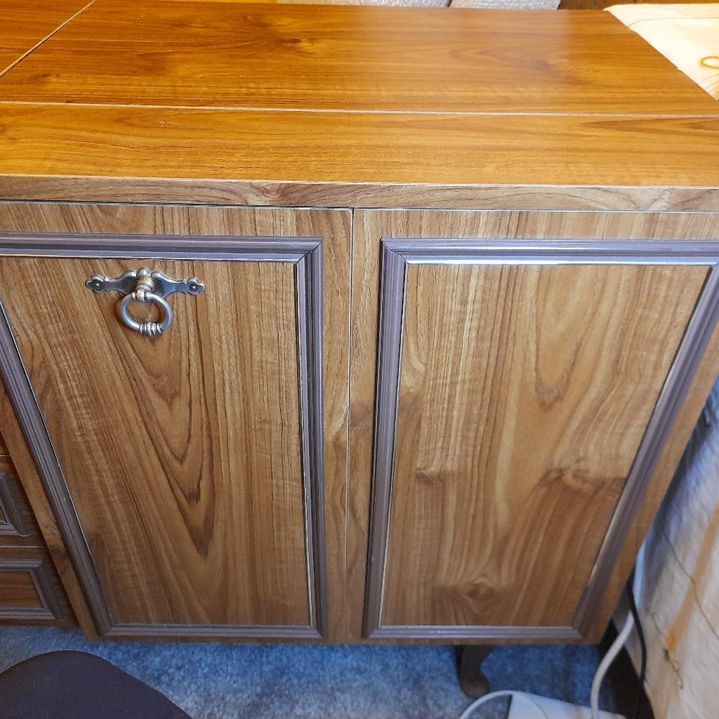 Light Oak sewing machine cabinet with 3 draws and lift up lid on top. It has 2 consatina doors and inside a shelf with macanical lift for your sewing machine. Immaculate condition, no marks or scratches. Size 40 inches long by 18 inches wide. Bargain price for quick sale need the space.