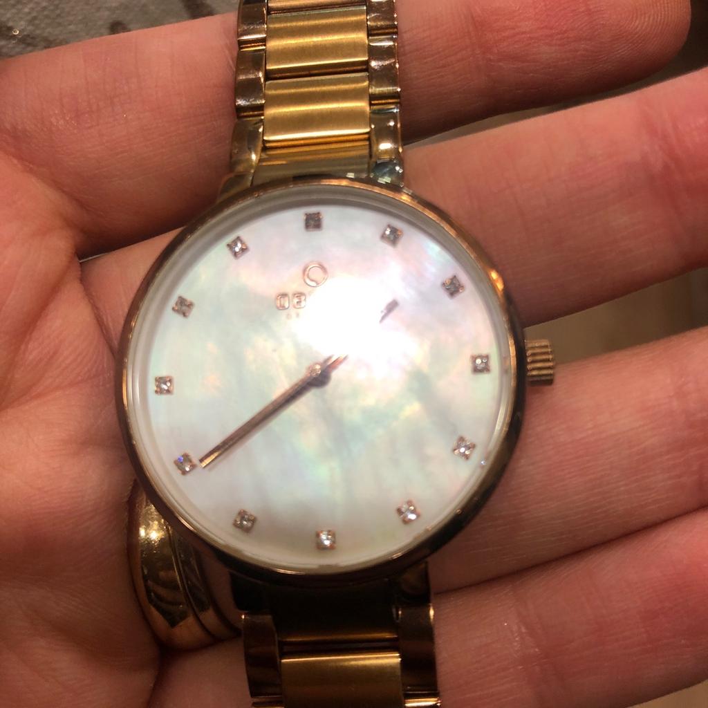 Danish watch brand Obaku. Mother of pearl dial with a rose gold coloured metal strap. Lovely watch and a great bargain