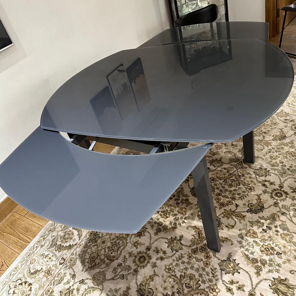 The table is now on sale for £600 (the last 2 pictures is the price and layout of the table in the shop), but I will sell it for £200. It is an extendable table: 90cm in width, 120cm in length when not extended and 180cm when extended. It is in good condition.