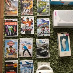 Nintendo Wii with controllers and balance board. Numerous games.