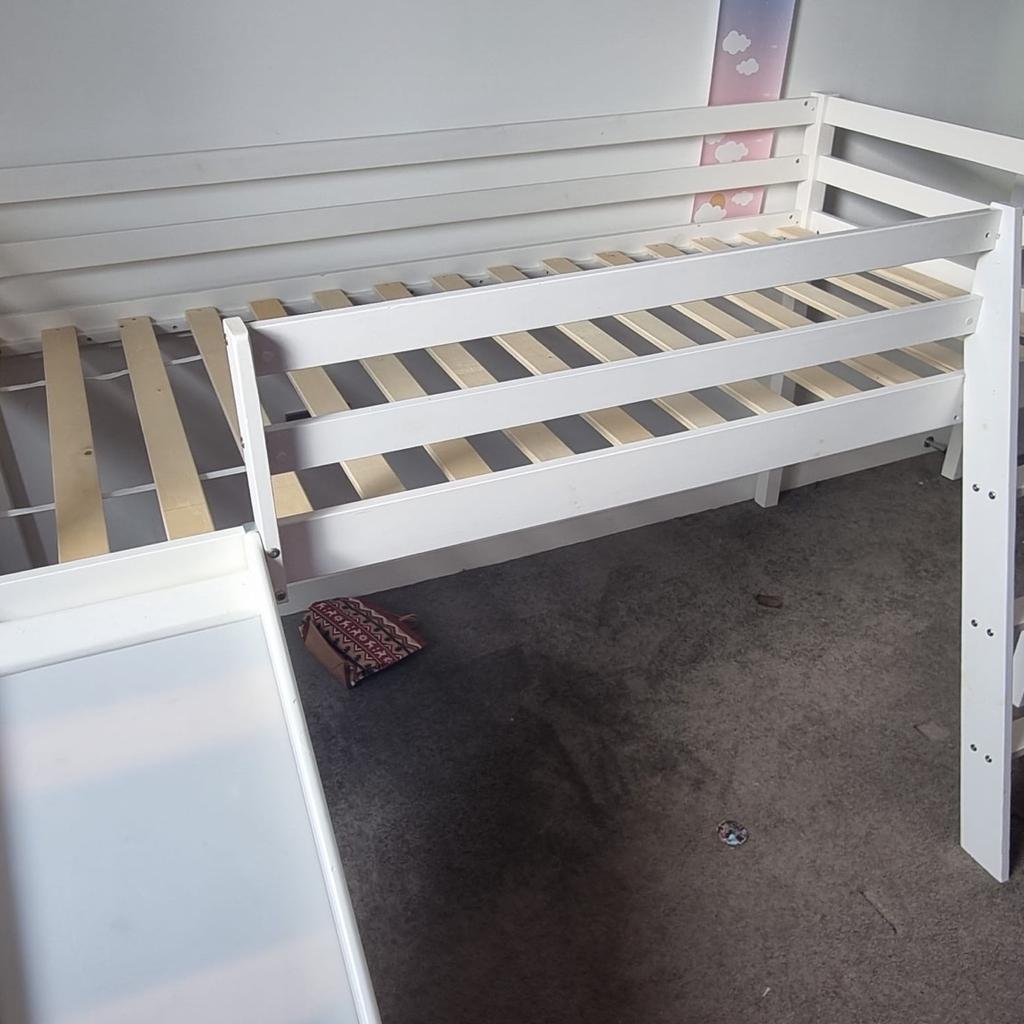 - High quality kid's wooden bed frame with ladder and slide in white.
- In good condition, with all parts and fixings present.
- Takes a standard UK single mattress (190x90cm, not included in sale).
- Slide and ladder can be at either end of bed to suit position in room.
- Partially dismantled for transportation. Reassembly instructions can be found on the product page on the Noa & Nani website.
- Please note, listing is for the frame/ladder/slide only. None of the soft furnishings in photos are for sale.

FROM THE NOA & NANI WEBSITE:
"The Midsleeper Cabin Bed Frame with Slide is made from solid pine wood, ensuring it's strong enough for your child's play while the mid sleeper level promotes a great night's sleep! Children adore sliding out of bed in a morning ready to start a brand new day, while parents love having the ability to tidy everything away!"

Dimensions:
Overall: Length 202cm x Width 101cm x Height 114cm
Ladder Extends: Approximately 33cm
Slide Extends: Approximately 145cm