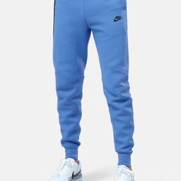 Ready for cooler weather, the Nike Sportswear Tech Fleece Joggers feature an updated fit perfect for everyday wear. Roomy through the thigh, this tapered design narrows at the knee to give you a comfortable feel without losing the clean, tailored look you love. Tall ribbed cuffs complete the jogger look while a zippered pocket on the right leg provides secure small-item storage and elevate the look. Smooth on both sides, Tech Fleece offers premium warmth and an elevated look without adding weight or bulk. Bonded tape around the zippered pocket and at seam details are signature Tech Fleece details. Within the zippered pocket is an extra interior pocket to help keep your keys, cards and phone in place and easy to grab. Room in the thighs helps you move without restriction. Tapering at the knee provides a tailored look to help your sneakers shine. Elastic waistband with drawcord provides a snug fit.