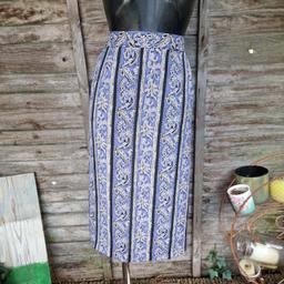 Vintage 1990s pencil skirt. Midi length blue, white, and black floral pattern. Attached white underskirt. Part elasticated waistband. Zip up back. Overlapping slit. 
Label says size 18
Waist measures 34"
Length 29"
Polyester 
The waistband has lost some of the elasticity.