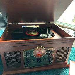 Vinyl record player with Bluetooth, aux, cd player and radio all in one.
Beautiful addition to a classy home with a retro rustic vibe