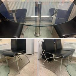 Circular glass table with four black leather seats. Brand-new would be worth £200+ on most sites.
1 of the chairs has some minor damage.