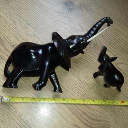 2 Vintage African Wood Carvings:
ELEPHANTS 🐘🐘Beautifully carved ebony wood with a lovely patina

(Elephants with raised trunks considered lucky)

The larger elephant has suffered a broken tusk (price reflects this) but is quite easily repairable

*Postage possible at buyer's expense with Payment by PayPal so buyer protection will apply