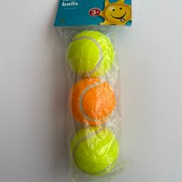 Set of 3 tennis balls, 2 yellow one orange.