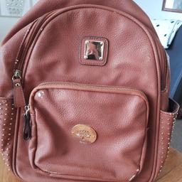 Brown backpack with diamonties on both sides zip compartment at back zip compartment at front zip compartment inside few peel of marks of material hence liw price soft material