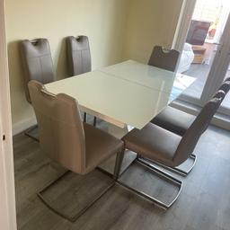 (Hartlepool) Beautiful white glass extendable table with six grey chairs. Little bit of wear on one of the chairs as shown in the photo. Measurements Width 3foot length 5’3 when extended 6’6. £200,No time wasters please.