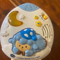 V tech cot lullaby light and music device. This plays a variety of lullabies and sushing sounds - it has a projector and can play a cute sheep cartoon onto ceiling/wall which baby will find relaxing. Uses AA batteries.