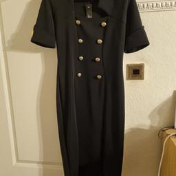 very smart black dress adorned with gold buttons, smart work dress or evening out, has not been worn, has some stretch.