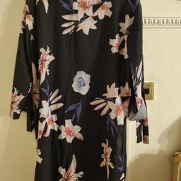 lightweight floral dress, says XL, fit around size 14, sleeves can be rolled up and tied.