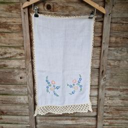 Vintage 1950s linen sideboard/ dressing table tablecloth. White with a cream lace border. Embroidered pink, blue, lilac, yellow, and green floral and leaf design.
Measures 24.5"×14.5"
There's a light mark.