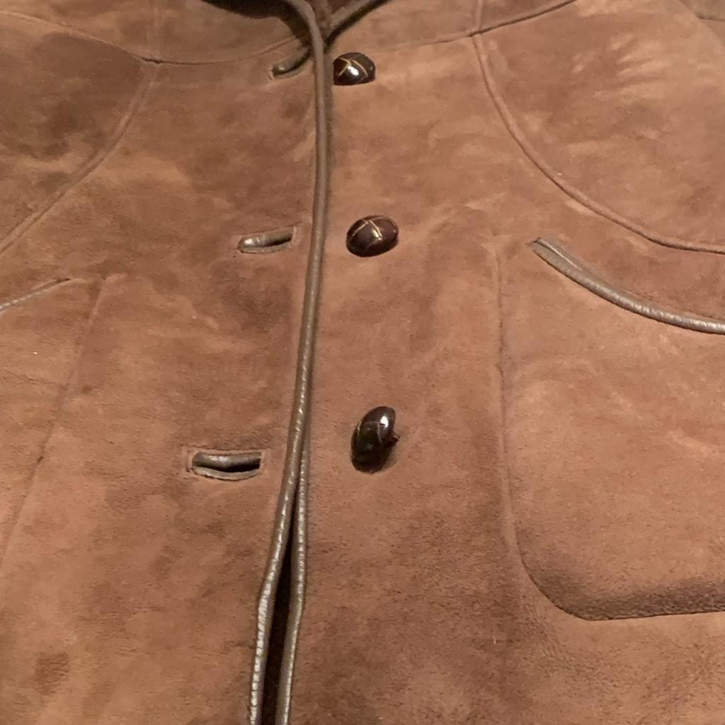Absolutely wonderful condition medium brown sheepskin wit dark brown thick sheepskin lining button front with 2 front pockets armpits to under armpits 20 inches from collar 33 inches