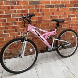 Get ready to ride in style with this ladies' pink Trax mountain bike! Conquer any trail with confidence and flair. Lightweight, durable, and designed for adventure. Own the road, the trails, and the spotlight. Grab this beauty today and pedal towards your next adventure!