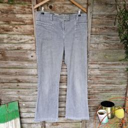 Vintage 1990s Next bootcut flared jeans. Distressed grey cord. Mid rise. Zip and double button fastening mini strap. Belt loops. Front and back pockets. Satin trim on pockets, belt loops, and inside waistband. Buckle strap at the back of the waist with cut-out v.
Label says size 14 regular
Waist measures 36"
Inside leg measures 30"
98% cotton 2% elastene