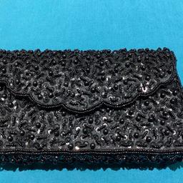Fabulous black beaded evening shoulder bag  with scalloped edge Fabulous black beaded evening shoulder bag
8” x  5” x 1 1/2”
Internal pocket
Secure popper fastening
There are two very small areas lacking beads but this is  hardly noticeable and the beads next to these are secure and not affected.
