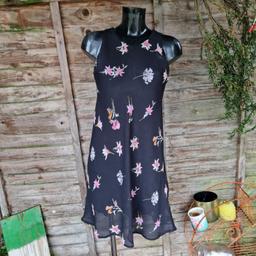 Vintage 1990s Topshop dress. Bias cut. Sheer black with pastel flowers. Flippy skirt. Sleeveless. Round high neck. 
Label states size 14.
Chest measures 38"
Waist measures 44"
Approx size 10 12
Faint deodorant marks under arms.