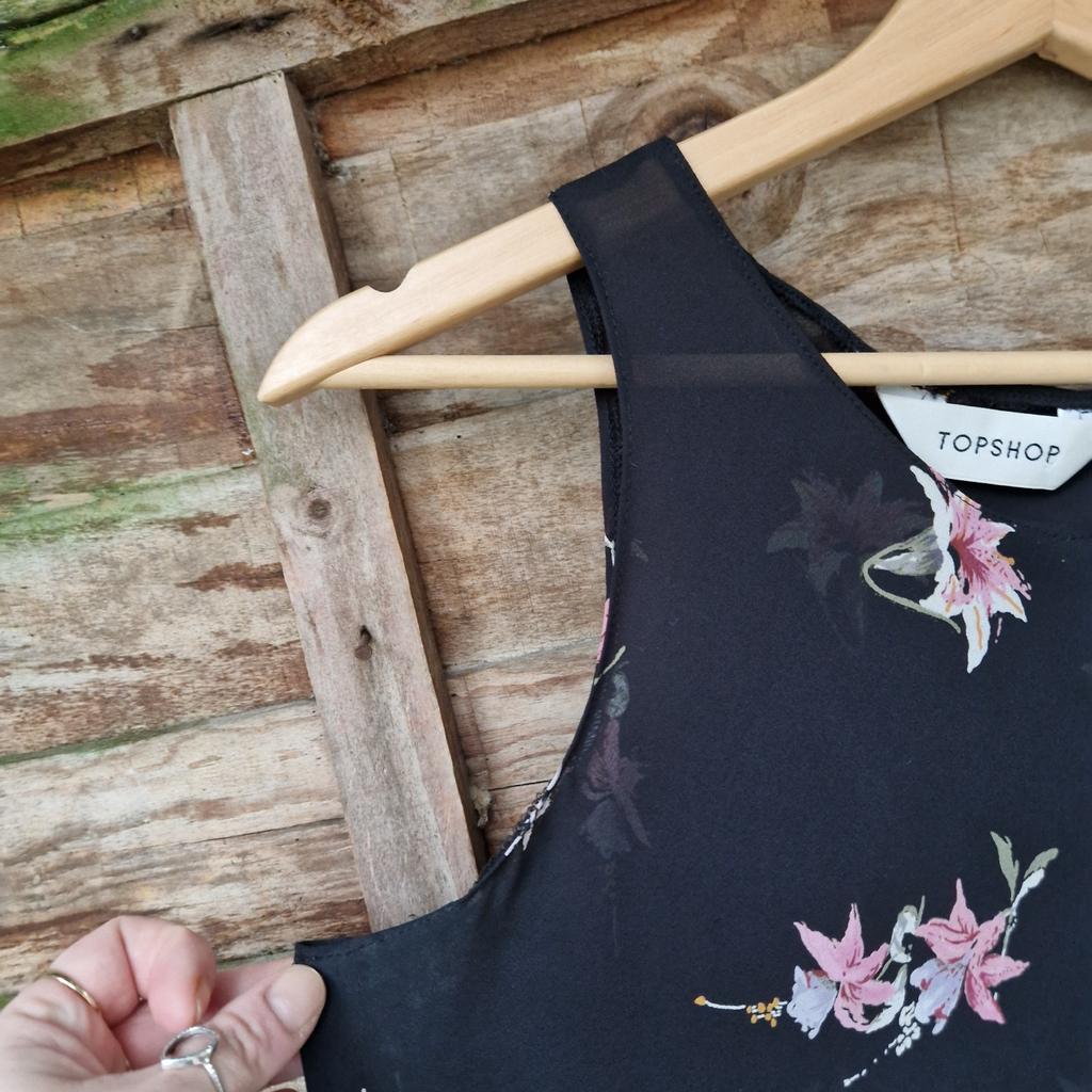Vintage 1990s Topshop dress. Bias cut. Sheer black with pastel flowers. Flippy skirt. Sleeveless. Round high neck.
Label states size 14.
Chest measures 38"
Waist measures 44"
Approx size 10 12
Faint deodorant marks under arms.