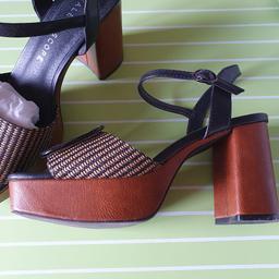 Ladies platform sandals, black and brown, with rafia style front and buckle decoration. Size Adult 6, heel height 3½ inches and platform height 1¼ inches. Good condition, with slight scuff to front of shoe, as shown in pictures. Great with summer dresses or jeans.