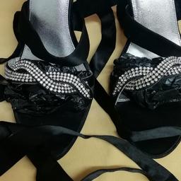 Lovely black diamanté designer shoes ,leather bottom shoesv,it has ribbons which wrap around ankle or up to calfc. Few gems have fallen off but not noticeable shown in pic hence bargain price