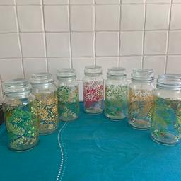 Nine prettily decorated storage jars (7 shown) for kitchen or other storage
Jars are 6” tall in total (5” jar + 1” lid) and 3” across base
I pink
2 yellow
6 green