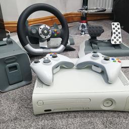 Used xbox 360. USB flaps are loose, but all functions are perfectly fine. comes with 2 controllers with wear and tear on Joysticks. A steering wheel and pedals. and a bonus of 18 games with an additional 5 games in the Arcade CD and 5 demo games.