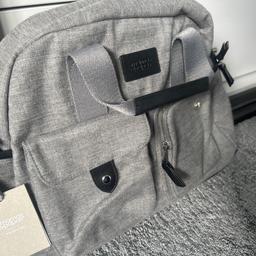Mamas and papas brand new grey baby changing bag,has several compartments inside and outside bag,comes with straps for shoulder hanging,comes with a pouch to put essentials in and a matching baby changing mat