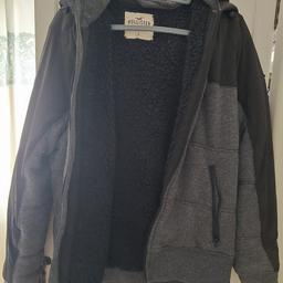 Hollister mens large jacket. Black and grey with logo. Never worn but without tags and packaging. Hooded jacket and fleece lined.