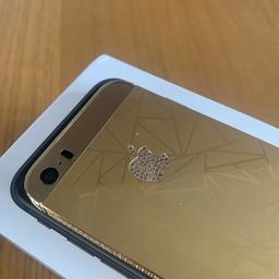 The iPhone 5S 24kt Gold edition with Swarovski crystals exudes unparalleled luxury and elegance.

This opulent device is adorned with a lavish 24-karat gold-plated exterior, imparting a regal sheen that captivates attention.