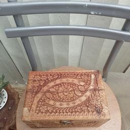 beautiful engraved, wooden  box. Has three compartments. red velvet inside lying.