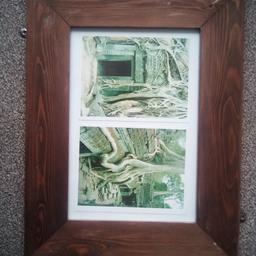 a lovely wooden frame with two pictures of Cambodian forest. 16" X 12" .