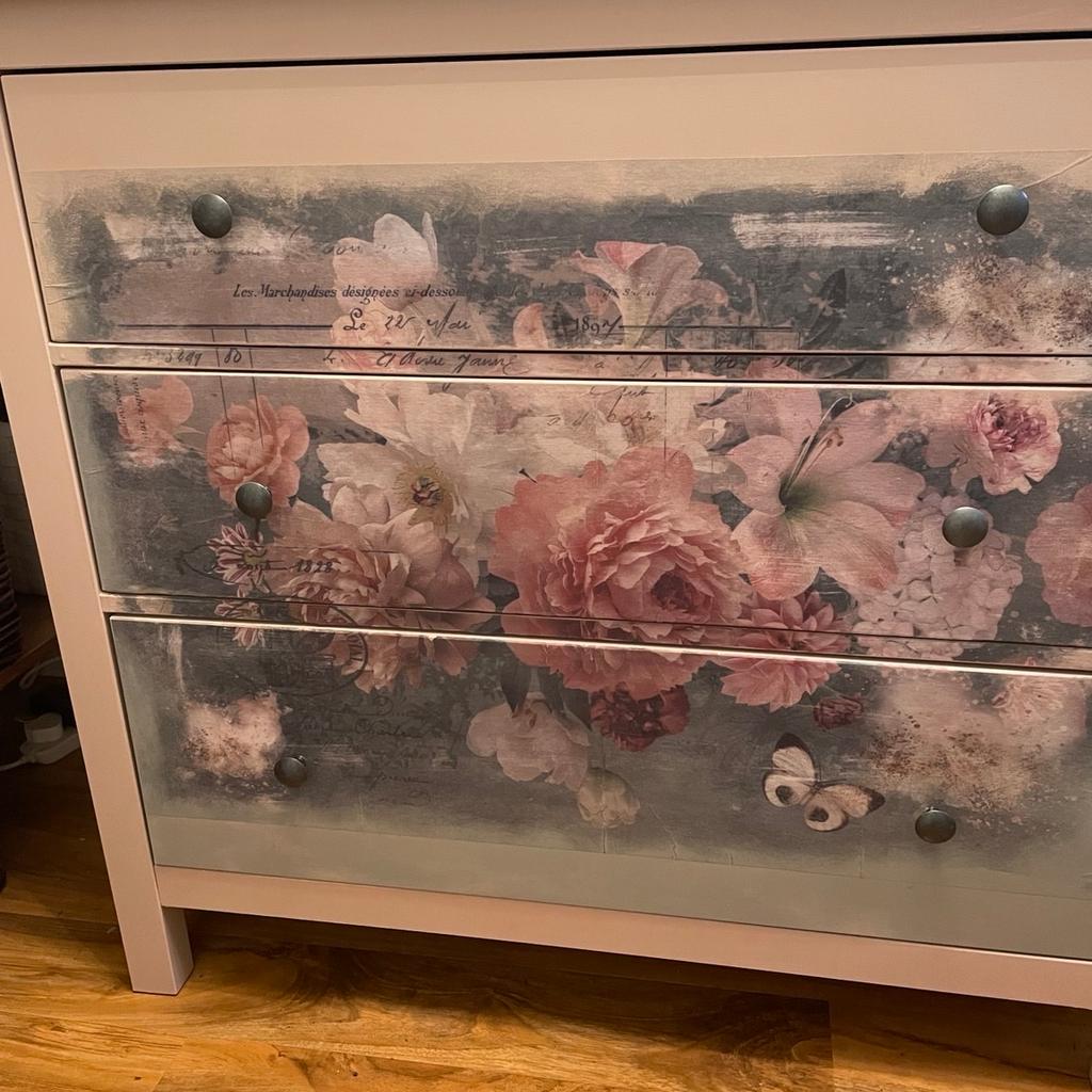 IKEA 3 draw cupboard. Has been painted in Frenchie nugget (pink) and deco parched with a flower design. The draws run very smoothly. A great cupboard for someone looking for something bespoke.