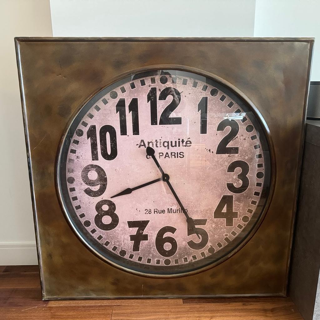 Large square industrial Antique de Paris clock which can either be a stand alone item or hung. Adding a rustic charm to your living room with this Large Square Industrial 'Antiquite De Paris' Wall Clock. The clock comes in a dark brown square frame with an antique look. The face comes with a brown statin look in a circular shape and is decorative with bold black numbers and hands. Requires one AA battery.

Height: 110cm
Width: 110cm
Depth: 9cm

I moved and the clock doesn’t fit the interior design. RRP £199 (purchase receipt can be provided). Collection from Brentford.
