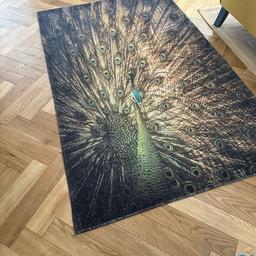 Lovely peacock rug. We currently use it in our kitchen/diner and it’s easy to keep clean.
180cm x 120cm